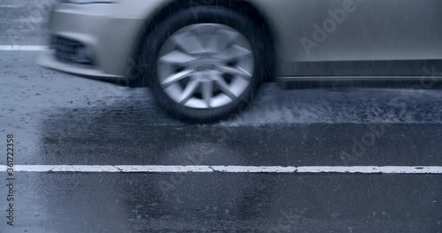 Car tire closeup on wet asphalt road