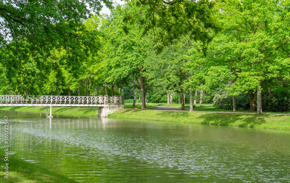 Moat with bridge in the Karlsaue in Kassel, Germany Moat with bridge in the Karlsaue in Kassel, Germany