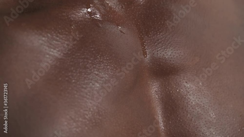 Close-up cropped shot of a tired sporty muscular sweaty man's chest. Drops of sweat on male body. Isolated on white background photo