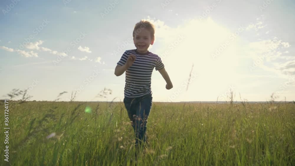 A happy, lovely child runs through a green wheat field. The boy dreams of traveling by plane with his family. A happy childhood is a healthy way of life. A happy, lovely child runs through a green wheat field. The boy dreams of traveling by plane with his family. A happy childhood is a healthy way of life.