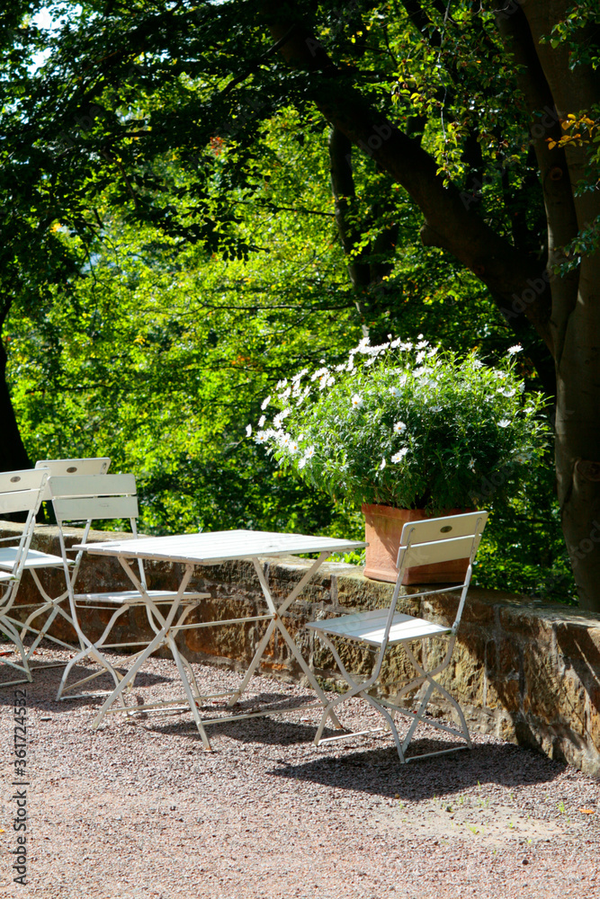 Gartencafe mit Tisch und Blumen