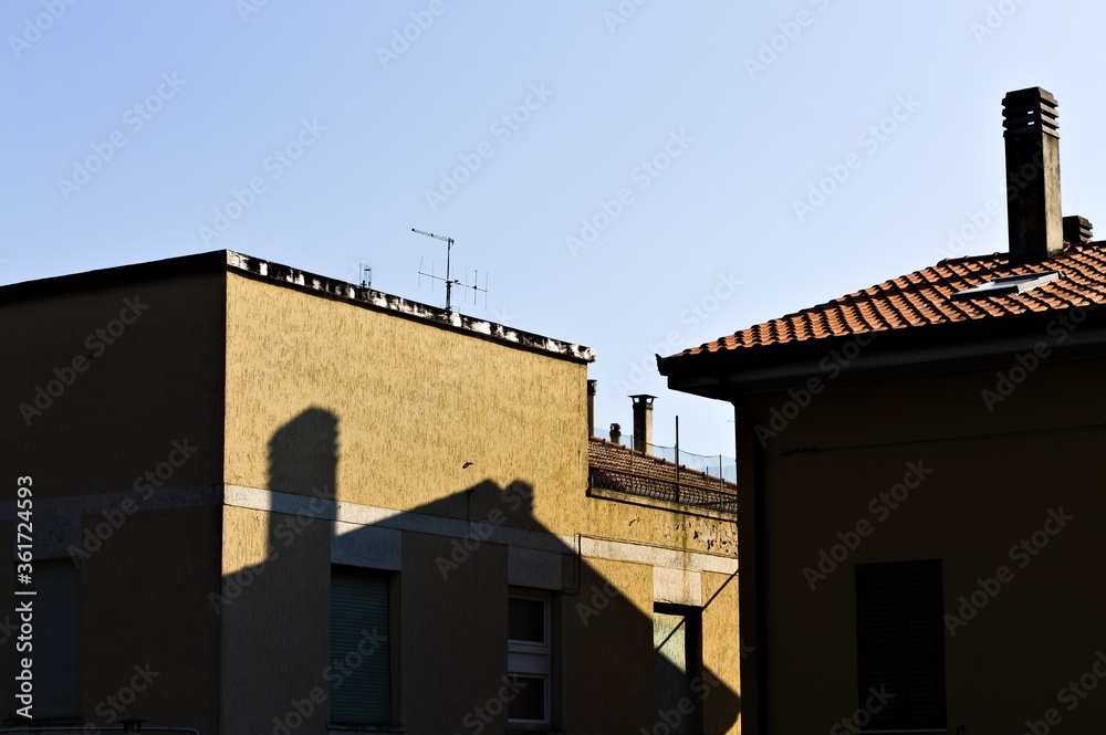The shadow of a chimney and a roof on a building wall (Pesaro, Italy, Europe)