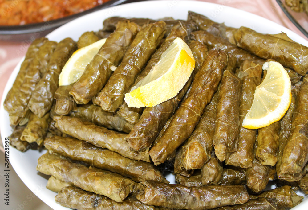 Traditinal sarma food in a plate, stuffed grape leaves with olive oil