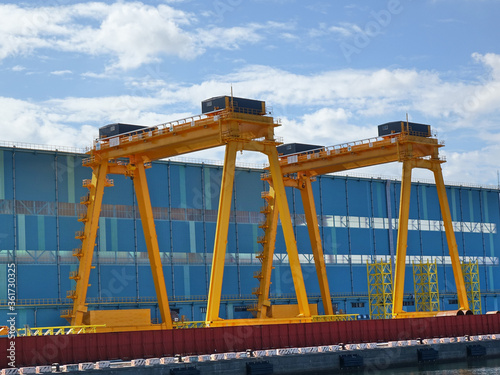 Two Large Yellow Gantry Cranes