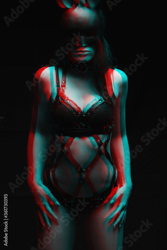 bdsm concept. sexy girl in black leather lingerie and a mask of a bunny. Glitch, black and white.