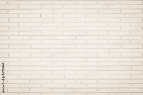 Background of wide cream brick wall texture. Old brown brick wall concrete or stone wall textured, wallpaper limestone abstract flooring/Grid uneven interior rock. Home or office design backdrop.