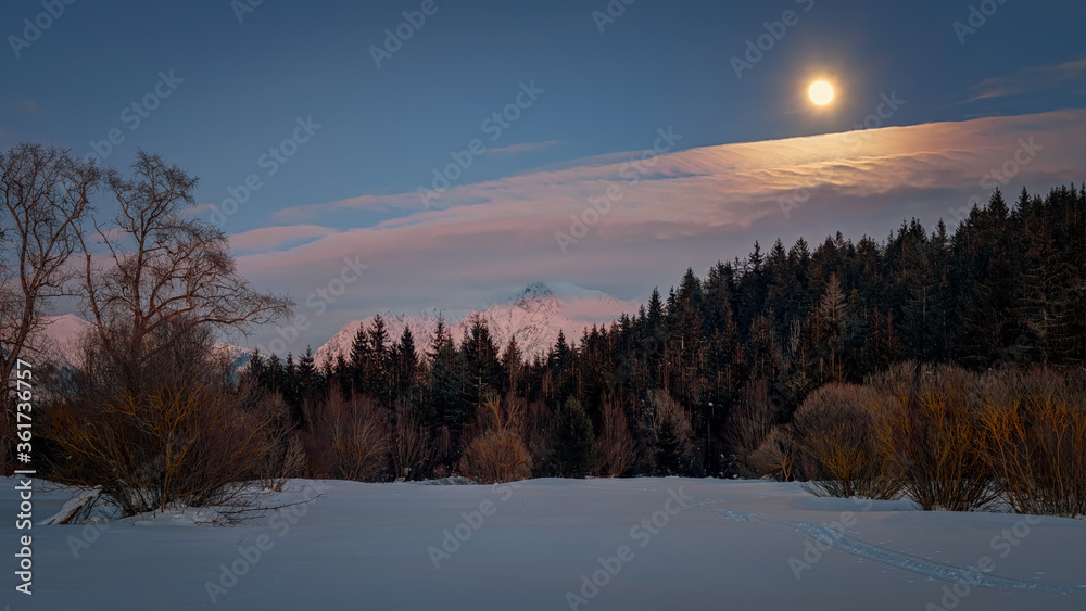 Krivan shield with the moon in full over a mountain river Krivan shield with the moon in full over a mountain river