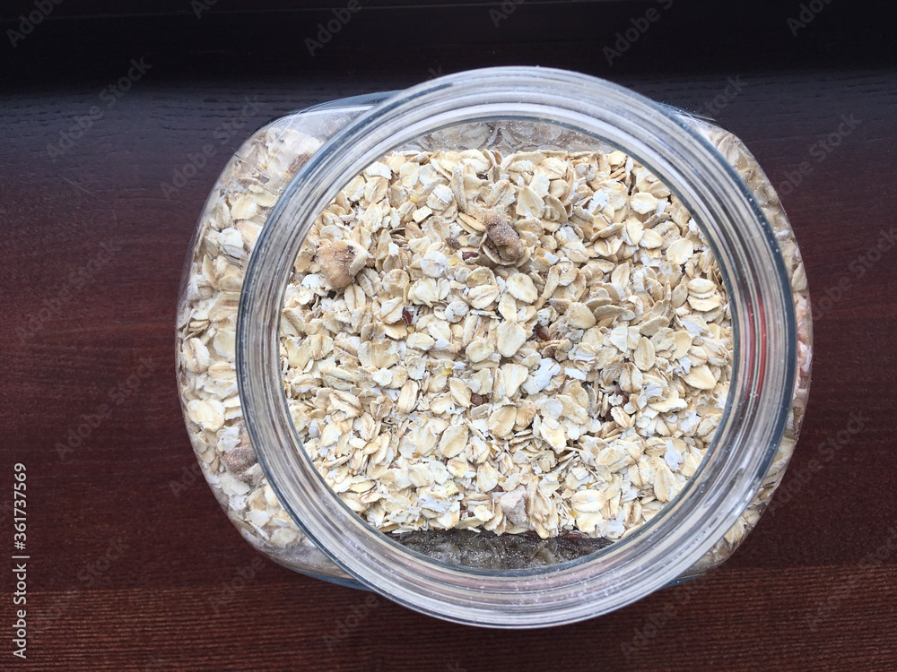 Photo of a glass jar filled with oatmeal, top view. Healthy eating concept.. High quality photo Photo of a glass jar filled with oatmeal, top view. Healthy eating concept.. High quality photo