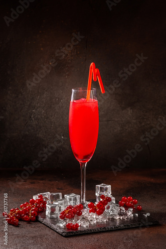 Delicious cold refreshing red smoothie drink in cocktail glass photo