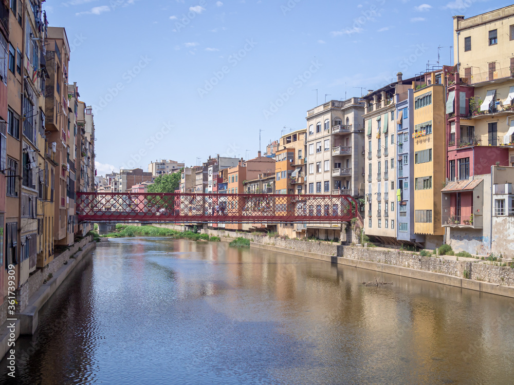 Girona City (Spain) view on red the Eiffel bridge over Onyar river