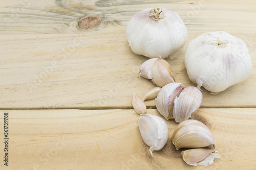 Raw garlic on wood table background copy space
