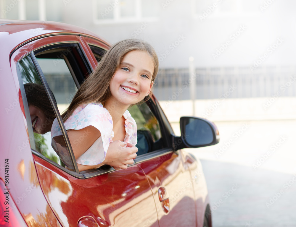 Happy cute little girl child looks out the window of the car Stock ...