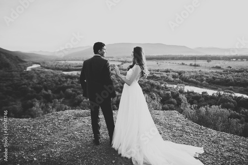 Beautiful wedding couple staying over beautiful landscape