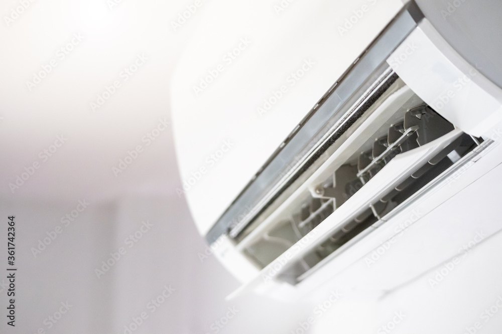Air conditioner on white wall room interior background Air conditioner on white wall room interior background