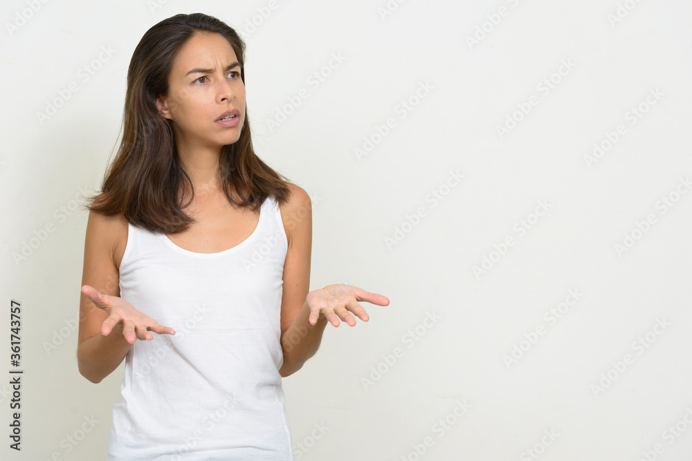Portrait of stressed multi ethnic woman shrugging shoulders Portrait of stressed multi ethnic woman shrugging shoulders