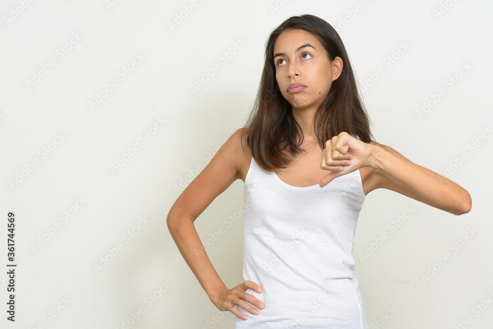 Portrait of stressed multi ethnic woman giving thumbs down Portrait of stressed multi ethnic woman giving thumbs down