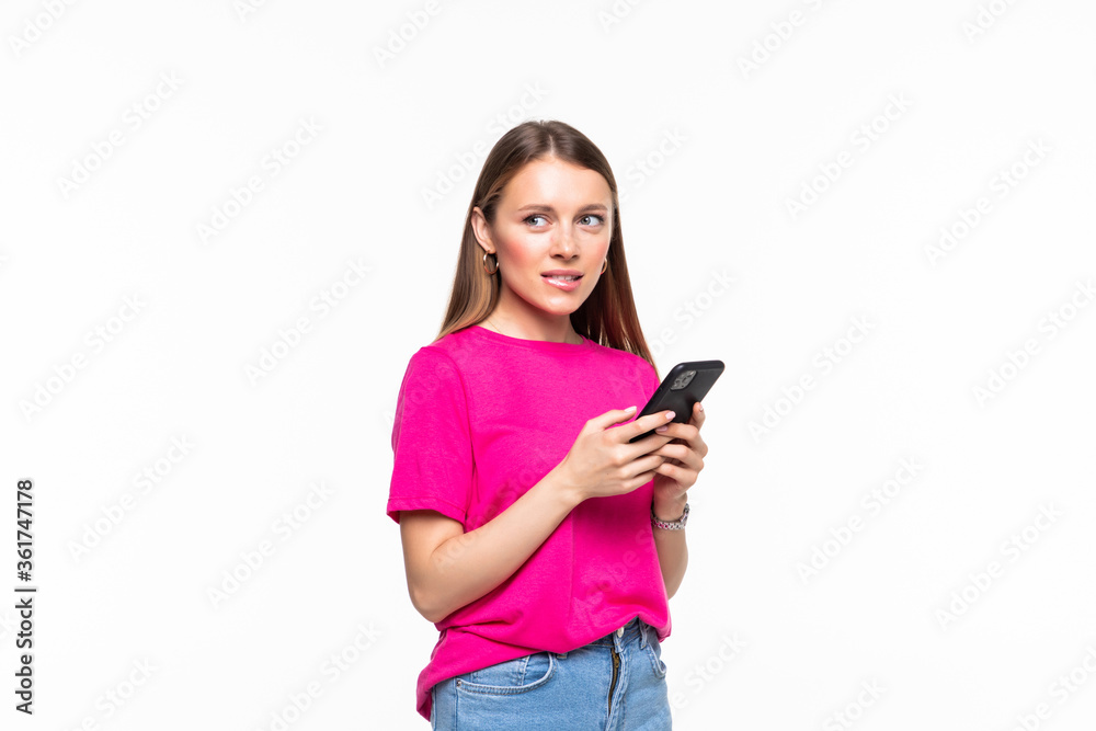 Smiling young girl text messaging on her mobile, isolated over white background Smiling young girl text messaging on her mobile, isolated over white background