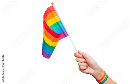 hand with a rainbow wrist strap holding a rainbow flag on a white background. Gay pride campaign. Gay pride LGBT concept