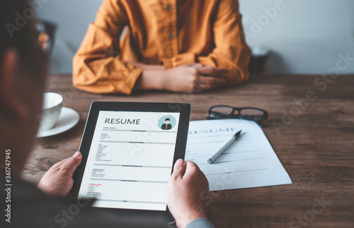 HR managers are interviewing job applicants who fill out their resume on the job application form in order to consider accepting a job as a company. photo