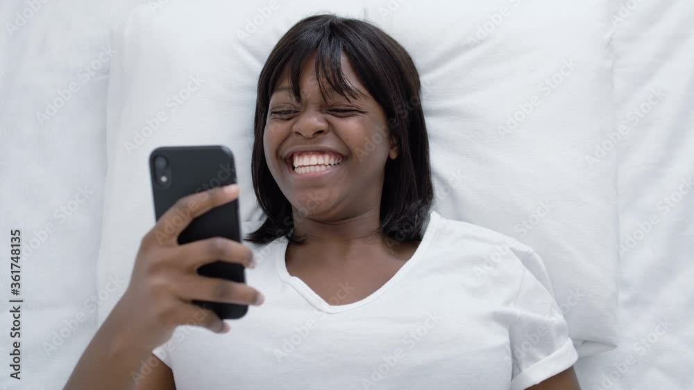 Cheerful african american lady reading message with good news, lottery victory Cheerful african american lady reading message with good news, lottery victory