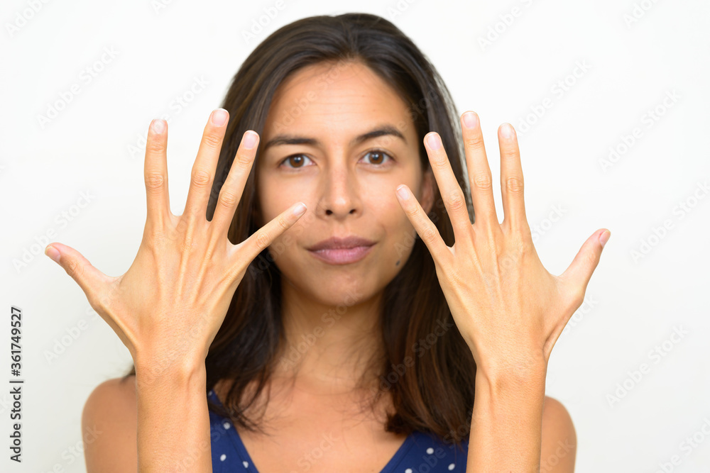 Face of beautiful multi ethnic tourist woman showing back of hands Face of beautiful multi ethnic tourist woman showing back of hands