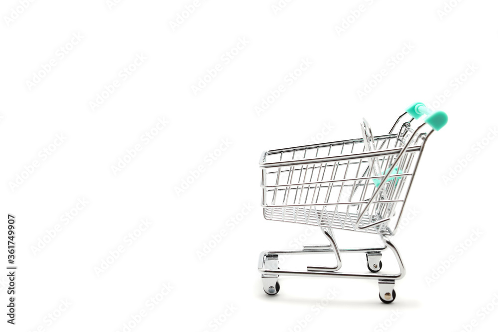 Miniature empty shopping cart on white background with copy space