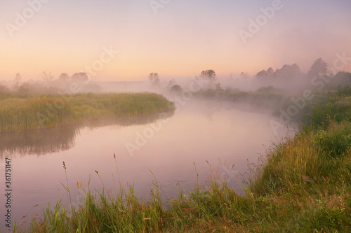 Morning fog on river. Beautiful summer sunrise landscape