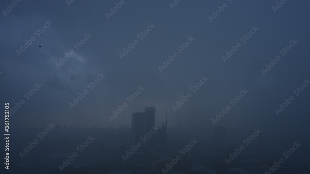 Aerial view, Tropical storm with heavy rain, high winds storm clouds fast moving over the city skyline.