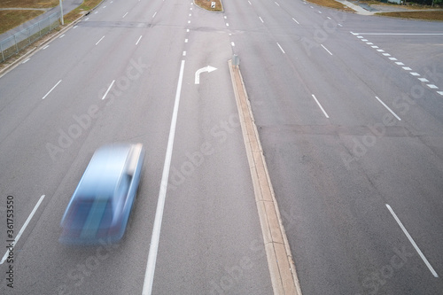 High angle view of a car zooming on a road