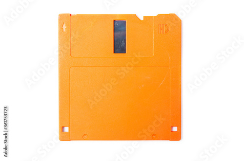 Floppy orange 3.5 on a white background. Floppy disk general plan and close-up. Floppy disk in a male hand on a white background