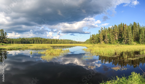Fototapeta Naklejka Na Ścianę i Meble -  Blue mirror lake reflections of clouds and landscape. Sudbury, Ontario, Canada.