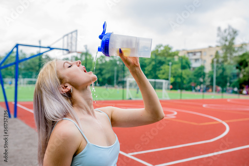 Young woman drinks water
