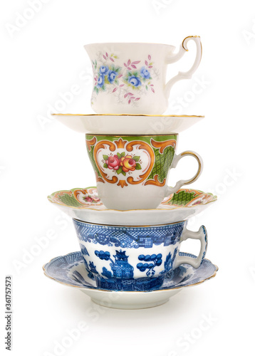 Stack of a variety of teacups on a completely white background. Contains clipping path.