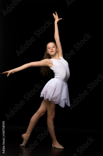 Full length portrait of a charming gymnast girl in elegant dress.