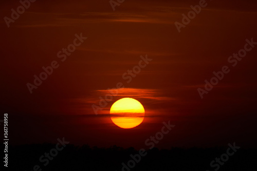 Fiery sunset and big sun