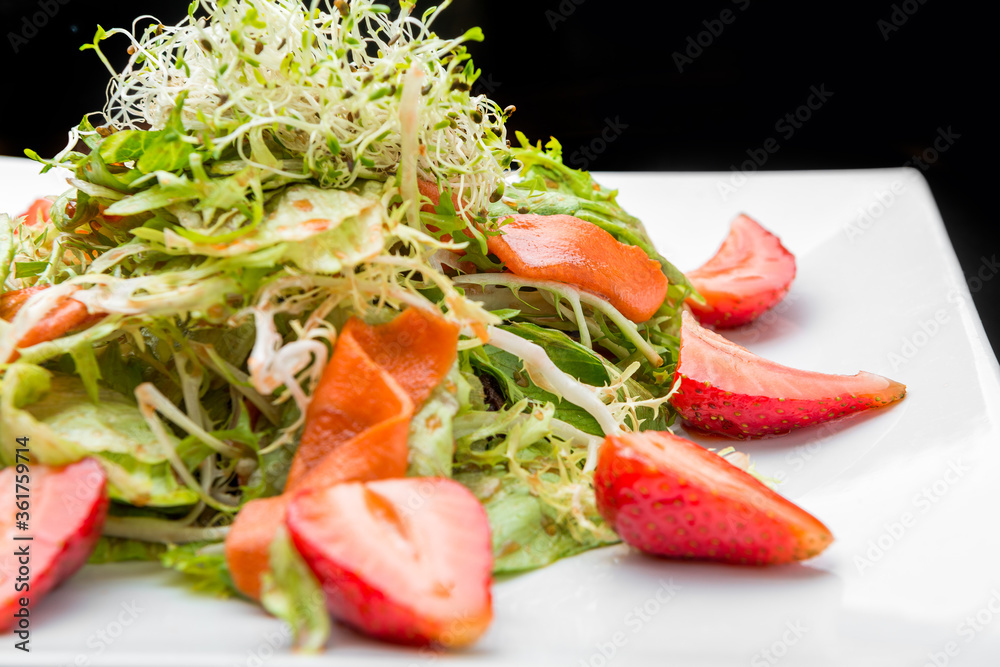 Strawberry, avocado, lettuce salad with cashew nuts on plate Strawberry, avocado, lettuce salad with cashew nuts on plate