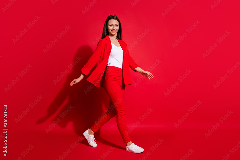 Full length profile photo of beautiful business successful lady walk conference seminar meeting wear luxury office blazer trousers suit white shirt footwear isolated red color background Full length profile photo of beautiful business successful lady walk conference seminar meeting wear luxury office blazer trousers suit white shirt footwear isolated red color background