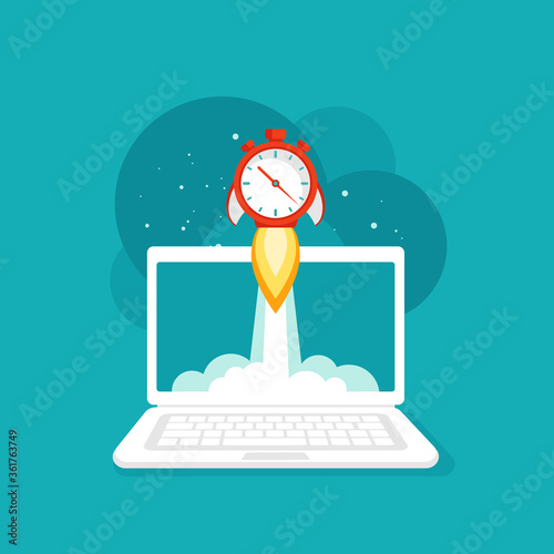 laptop screen with red stopwatch rocket ship flying out. workplace on blue background.