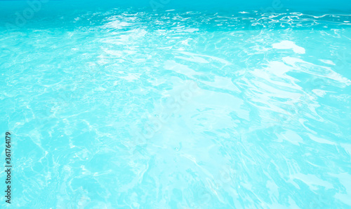 Surface of blue swimming pool. Background of blue ripped water in swimming pool