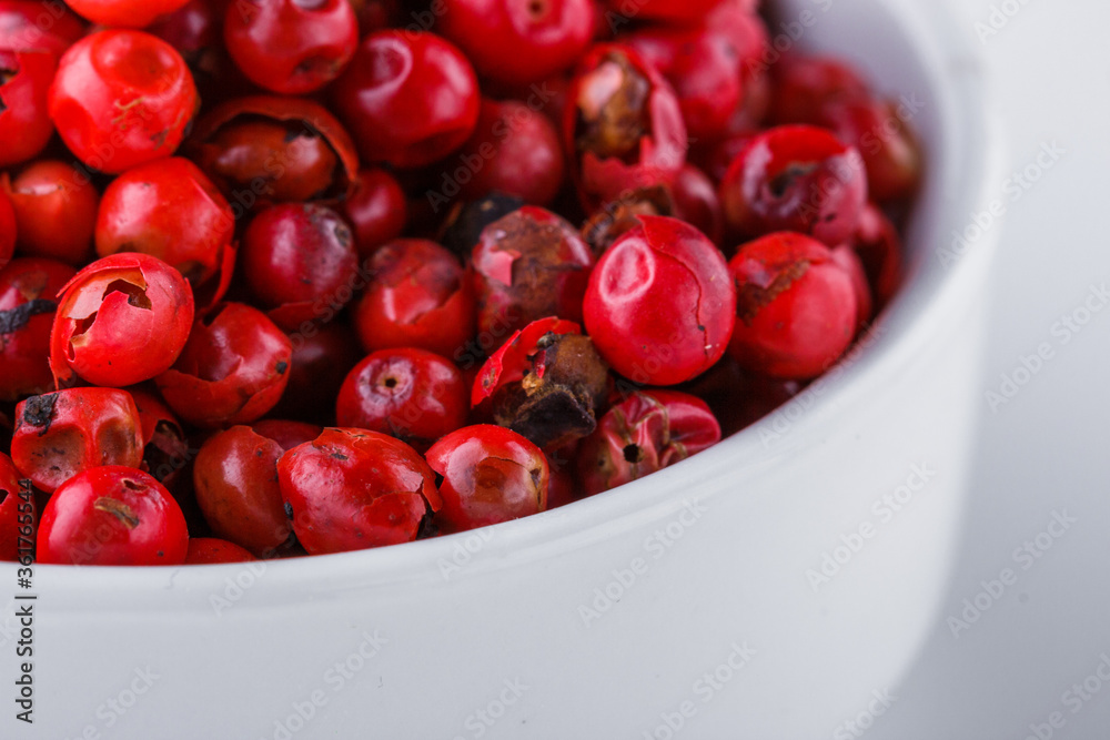 fragrant pink peppercorns on white acrylic background fragrant pink peppercorns on white acrylic background