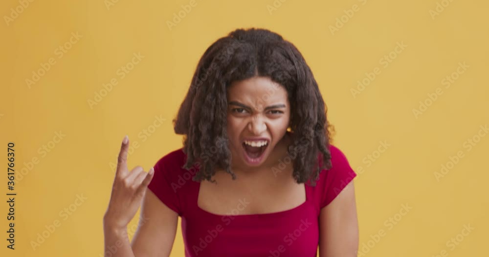 Cool african american girl making horn sign hand gesture Cool african american girl making horn sign hand gesture