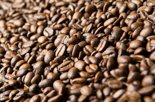 Roasted coffee beans background - full frame detail. Close up of a brown surface texture of aroma black caffeine drink ingredient for coffee beverage