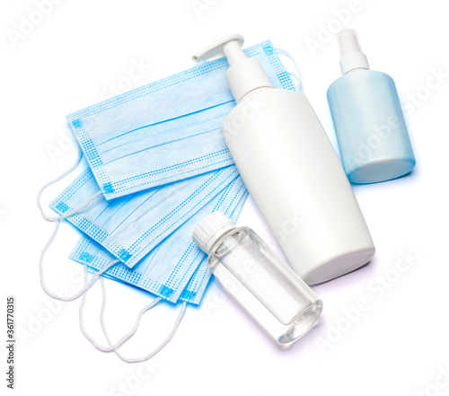 bottle of cream, lotion, sanitizer or liquid soap and protective mask isolated on white background