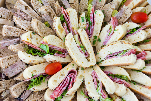 Фотография Close up of assorted french sandwiches on a catering wedding platter background