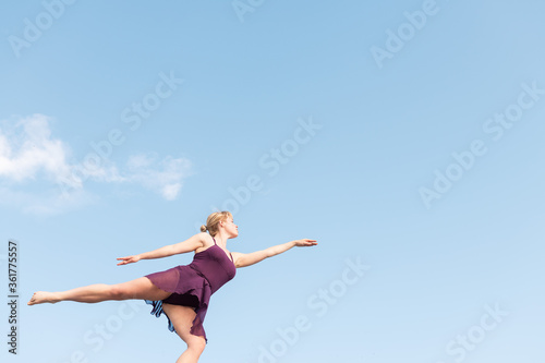 ballet dancer dancing with the sky at background