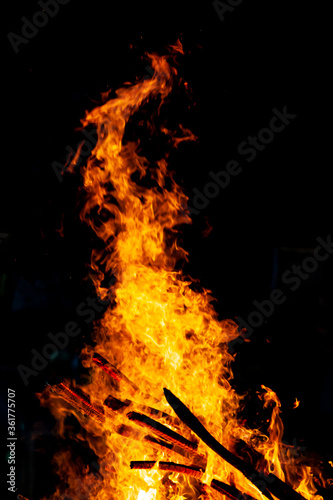 Bonfire that burns on a dark background, wood burning flame.