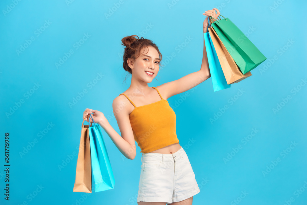 Beautiful young woman holding in her hands a few shopping bags, looking very happy. Beautiful young woman holding in her hands a few shopping bags, looking very happy.
