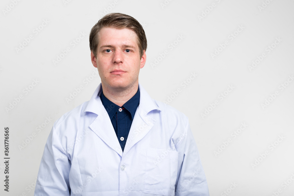 Portrait of young handsome man doctor looking at camera Portrait of young handsome man doctor looking at camera