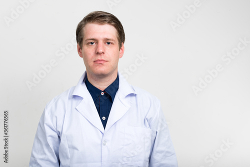 Portrait of young handsome man doctor looking at camera © Ranta Images