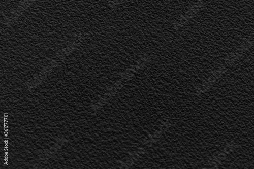 black concrete stone texture for background in black. Cement and sand grey dark detail covering.